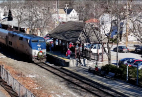 The downeaster train stopped at the Exeter Train Platform as passengers wait to get on the train