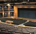 Exeter High School auditorium with many blue seats in front of a stage