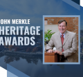 text reading "john merkle heritage awards" with a photo of john posing in a tan suit