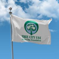Tree City USA flag in front of a blue sky 