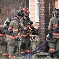 Exeter firefighters stand outside of a building