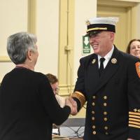 New Fire Chief Justin Pizon shakes hands with Town Clerk Andie Kohler after being sworn in