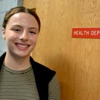 Exeter's newest Health Officer Madison Bailey in front of the Health Department door