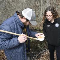 Health Officer Madison Bailey and Northeast Vegetation & Mosquito Control look at mosquito larvae