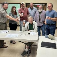 Members of the Exeter-Squamscott River Local Advisory Committee raise a toast to Don Clement in celebration of Don being awarded