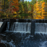 pickpocket dam in the fall with water flowing over the falls