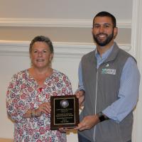 Cheryl Rossman and Dave Tovey hold a plaque for their senior organization award