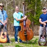 3 people standing in front of their instruments 2 guitars and a chello