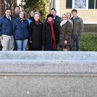 Mrs. Webb and family stand with Selectwoman Julie Gilman and Senior Executive Assistant Pam McElroy in front of the trough