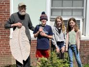 students and volunteer with big leaf magnolia