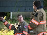 Two fire fighters talk to eachother