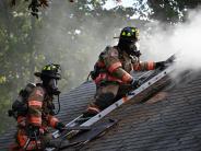 two fire fighters on a roof