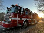 A red fire engine sits parked on the side of a road