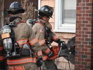 two fire fighters cut into a chimney 