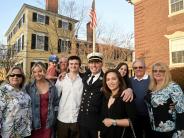 New Fire Chief Justin Pizon stands on Water Street with members of his family