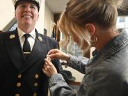 New Fire Chief Justin Pizon having his badge pinned on