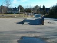 A skate ramp with some rust visible on the adjoining rails 