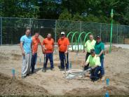 The construction crew in front of the site before the cement laying