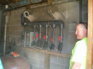 A worker stands in front of the water management panel 