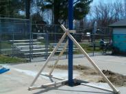 The partially constructed umbrella stands with the help of white support beams 