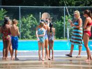 people walking around a pool