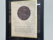 A framed copper plate with test describing the bandstand