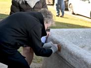 Mrs. Webb attaches plaque to the trough