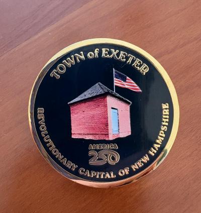 a photo of a blue pin with an image showing a small brick powder house with an american flag
