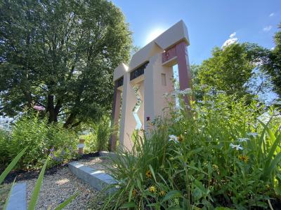 A concrete sculpture from Founders Park with the sun behind