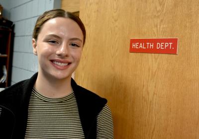 Exeter's newest Health Officer Madison Bailey in front of the Health Department door