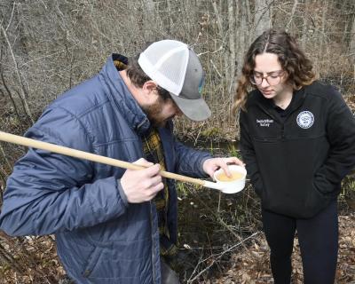 Health Officer Madison Bailey and Northeast Vegetation & Mosquito Control look at mosquito larvae