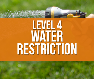 Level 4 Water Restriction in white letters on orange background on top of a picture of watering grass with a hose
