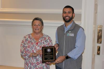 Cheryl Rossman and Dave Tovey hold a plaque for their senior organization award