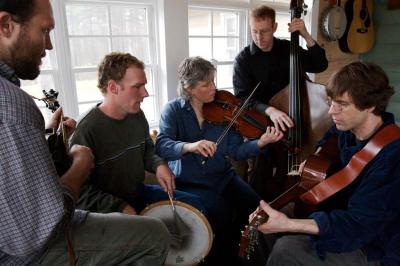 a group of people playing string instruments such as violins, cellos and more