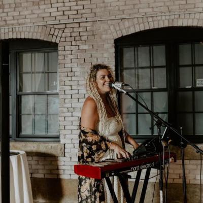 Woman playing the keyboard while singing