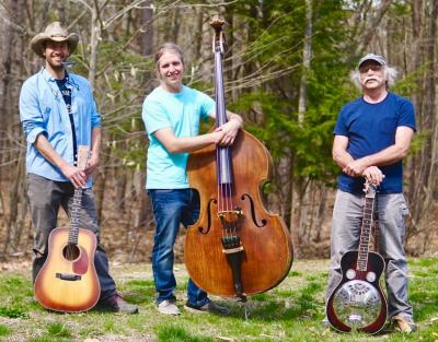 3 people standing in front of their instruments 2 guitars and a chello