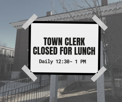 A picture of the Town Offices with a sign reading Town Clerk Closed for Lunch