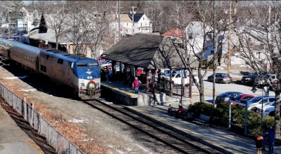 The downeaster train stopped at the Exeter Train Platform as passengers wait to get on the train